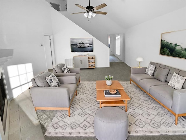 living room featuring high vaulted ceiling, ceiling fan, and light tile patterned flooring