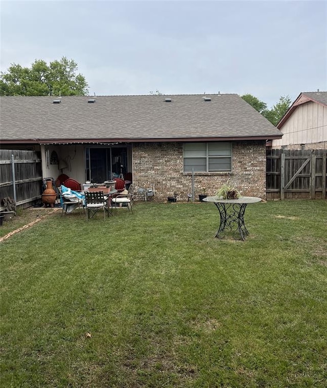 rear view of house featuring a lawn