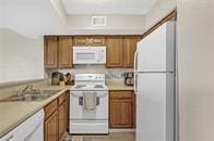 kitchen with white appliances and sink