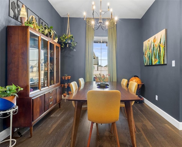 dining room featuring baseboards, an inviting chandelier, and wood finished floors