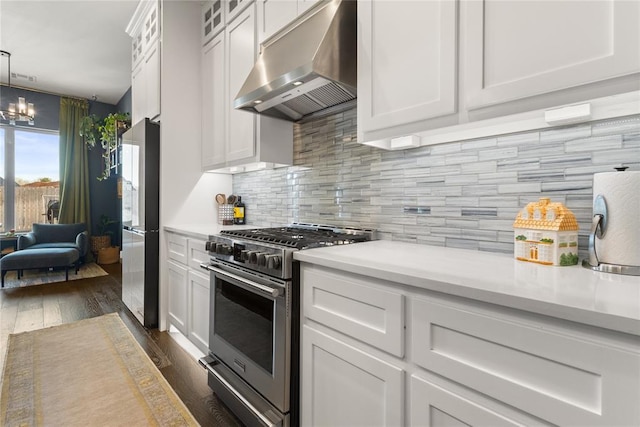 kitchen featuring dark wood-style flooring, light countertops, stainless steel appliances, and under cabinet range hood