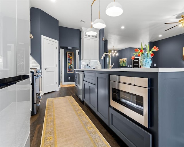 kitchen with white cabinetry, ceiling fan, dark wood-style floors, and stainless steel appliances