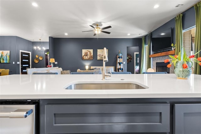 kitchen featuring visible vents, dishwasher, light countertops, open floor plan, and gray cabinetry