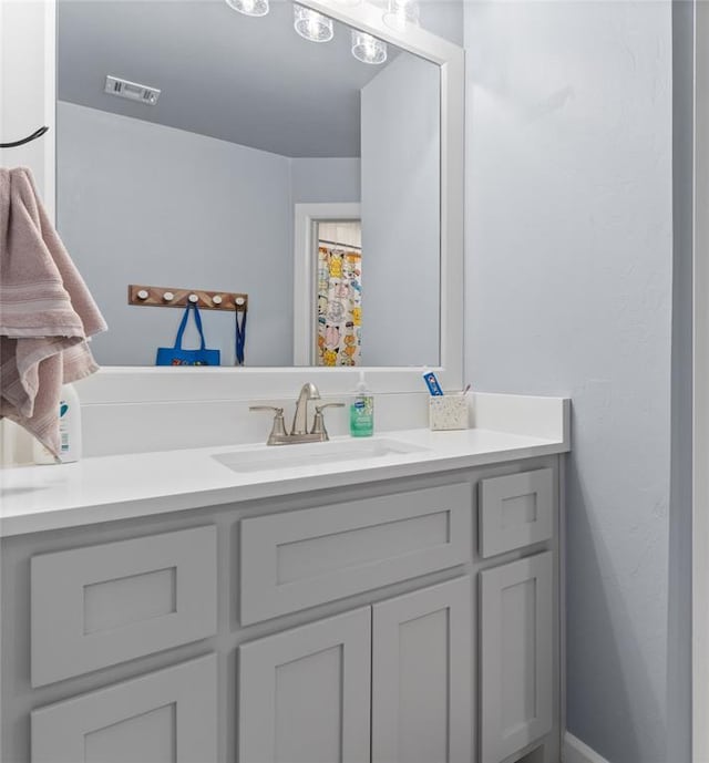 bathroom featuring vanity and visible vents
