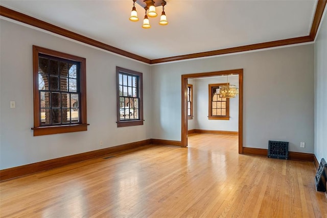 unfurnished room with crown molding, a chandelier, and light wood-type flooring