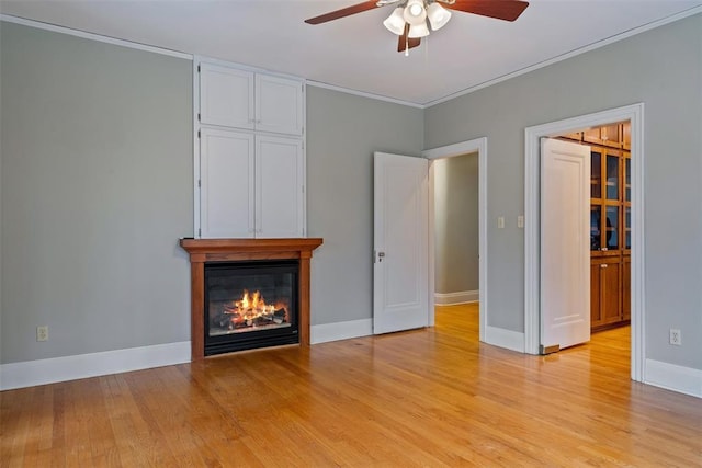 unfurnished living room with ornamental molding, ceiling fan, and light hardwood / wood-style floors