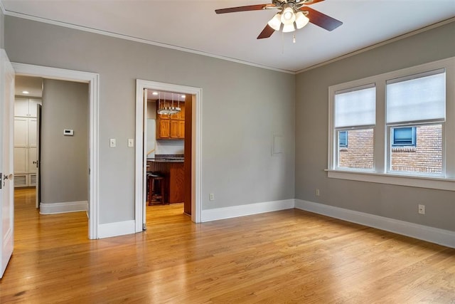 unfurnished room with ornamental molding, ceiling fan, and light hardwood / wood-style floors