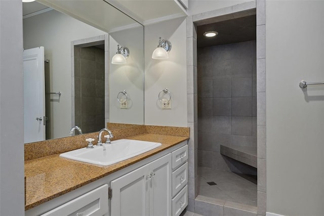 bathroom with vanity and tiled shower