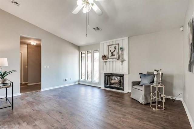 living room featuring a fireplace, hardwood / wood-style flooring, vaulted ceiling, and ceiling fan