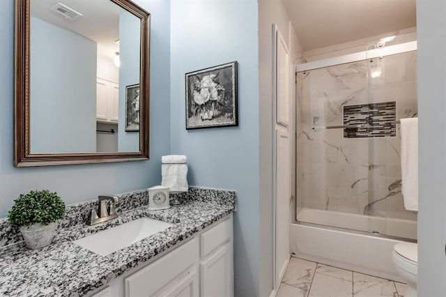 full bathroom featuring enclosed tub / shower combo, vanity, and toilet