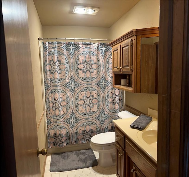 bathroom with tile patterned floors, vanity, and toilet