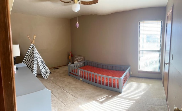 bedroom featuring ceiling fan and light colored carpet