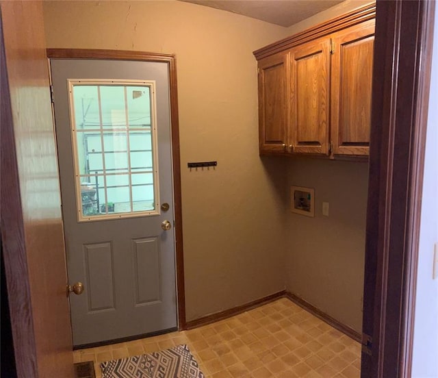 washroom with washer hookup and cabinets