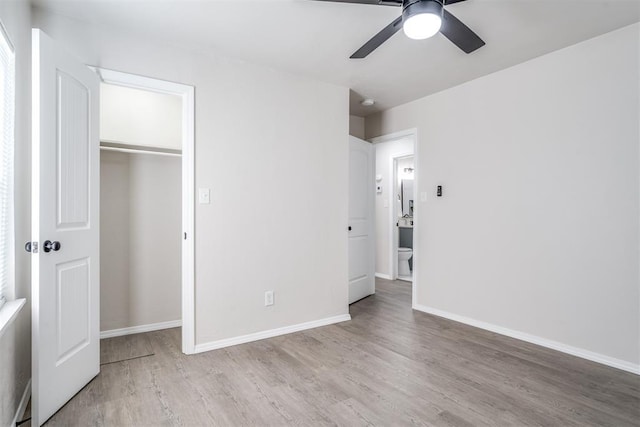 unfurnished bedroom featuring light hardwood / wood-style flooring, a closet, and ceiling fan