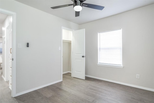 unfurnished bedroom featuring light hardwood / wood-style floors, a closet, and ceiling fan