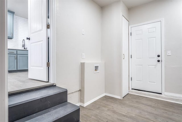 entrance foyer with sink and light hardwood / wood-style floors