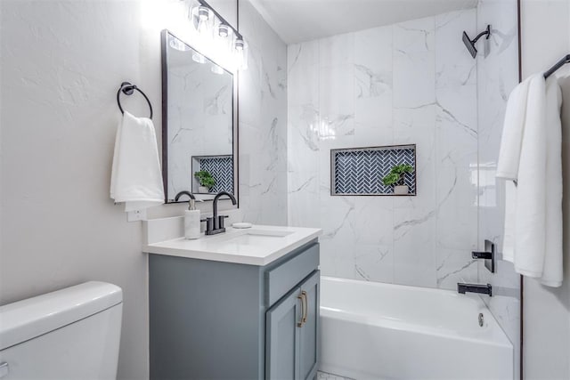 full bathroom featuring vanity, tiled shower / bath combo, and toilet