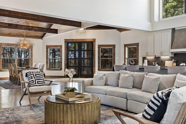 living room with beamed ceiling, high vaulted ceiling, hardwood / wood-style flooring, and a chandelier