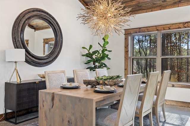 dining space with a chandelier and concrete floors