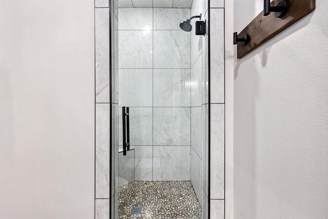 bathroom with a shower with door