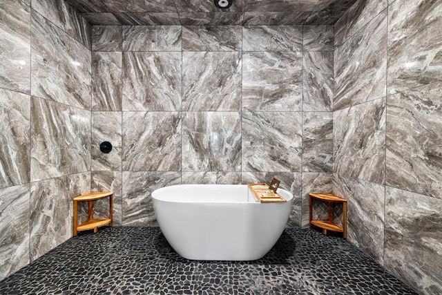 bathroom featuring a bathing tub and tile walls