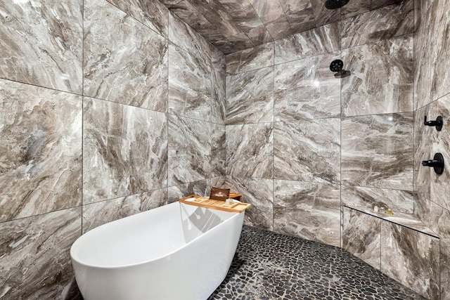 bathroom with a tub to relax in