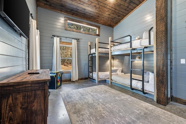 bedroom featuring lofted ceiling, wood ceiling, and wooden walls