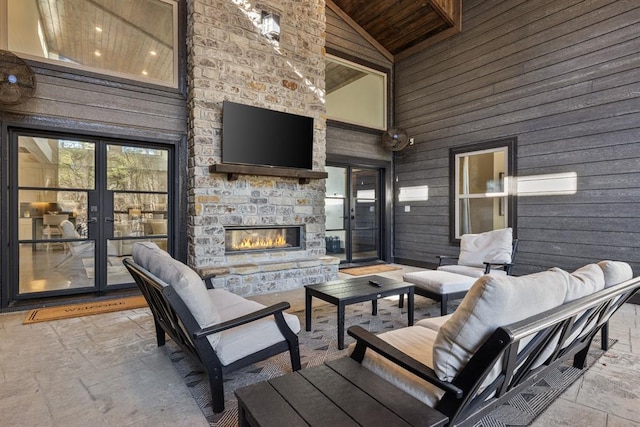 view of patio / terrace featuring an outdoor stone fireplace and french doors