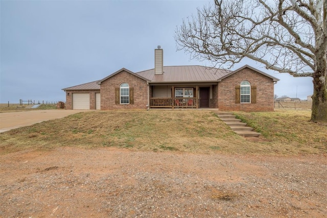 ranch-style house with a garage and covered porch