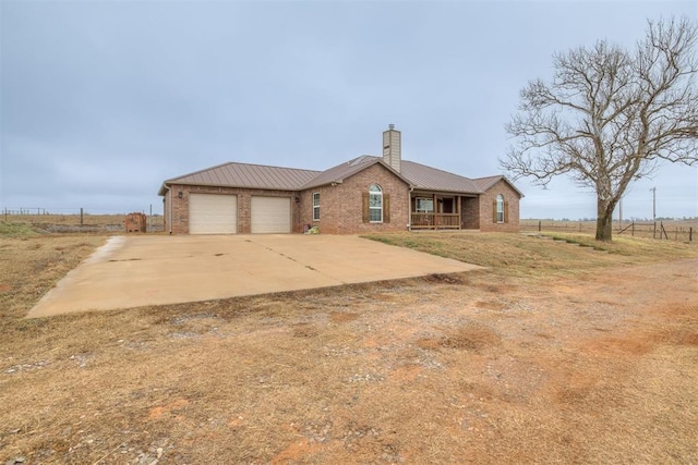 view of front of property with a porch, a garage, and a front yard