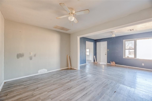 empty room featuring ceiling fan and light hardwood / wood-style flooring