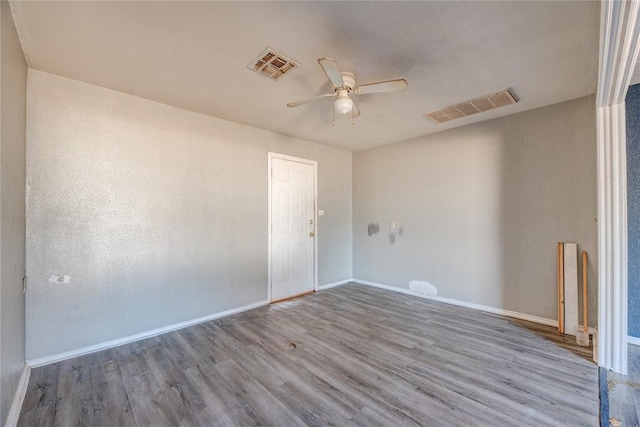 spare room with wood-type flooring and ceiling fan