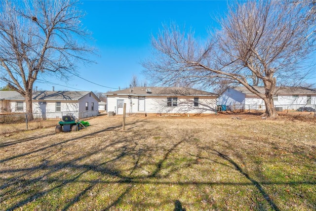 back of property featuring a yard