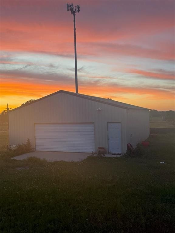 728 S Carol St, Carnegie, OK 73015 - view of garage at dusk