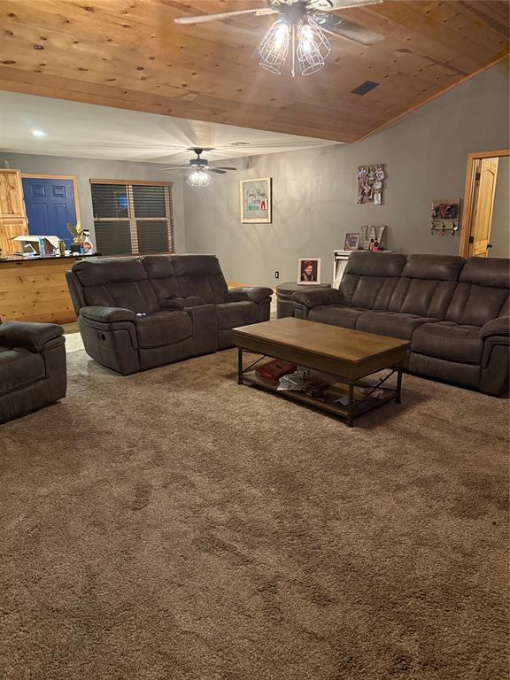 728 S Carol St, Carnegie, OK 73015 - carpeted living area with wooden ceiling, ceiling fan, and vaulted ceiling