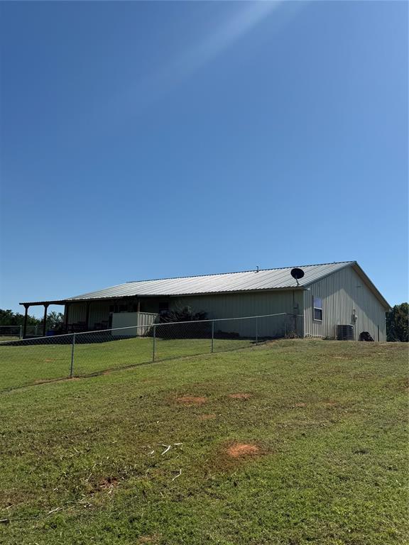 728 S Carol St, Carnegie, OK 73015 - rear view of house with an outbuilding and metal roof