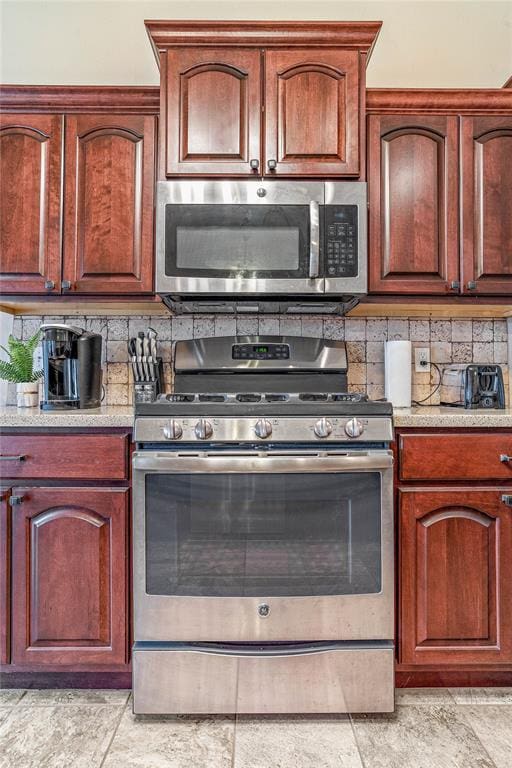 kitchen featuring stainless steel appliances and decorative backsplash