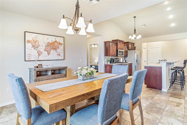 dining room with lofted ceiling and a notable chandelier