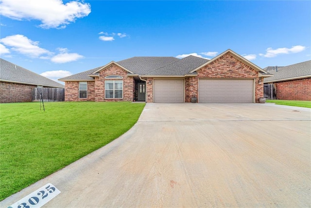 ranch-style home featuring a garage and a front lawn