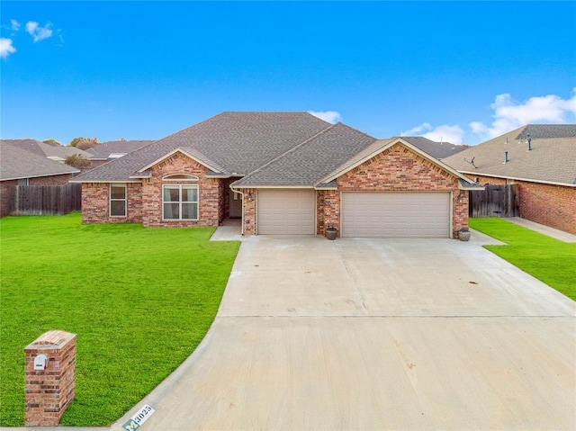 ranch-style house featuring a garage and a front yard