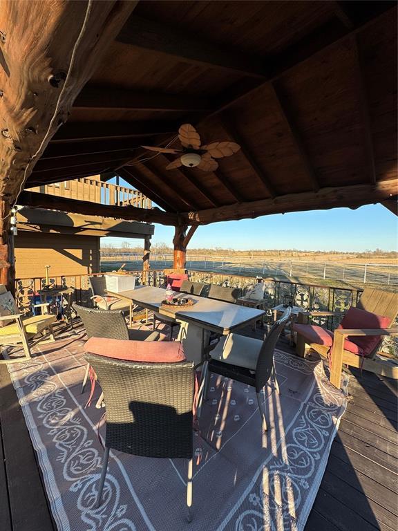 view of patio featuring a deck, a gazebo, and ceiling fan