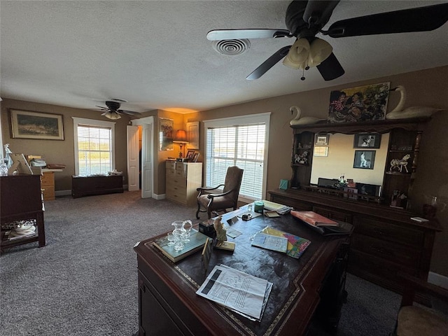 home office featuring a textured ceiling, carpet, and ceiling fan