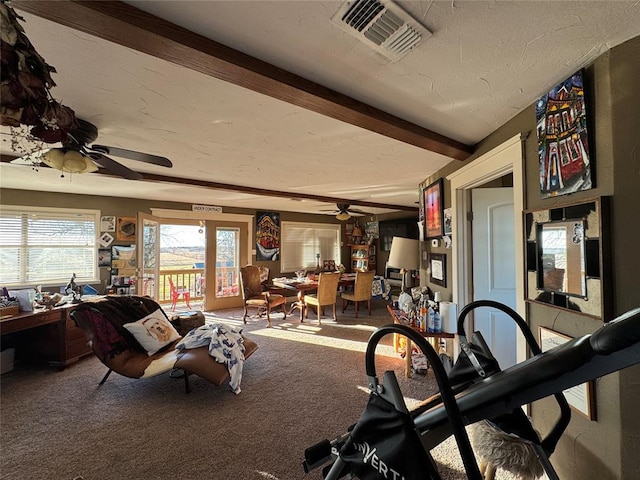 carpeted living room with ceiling fan