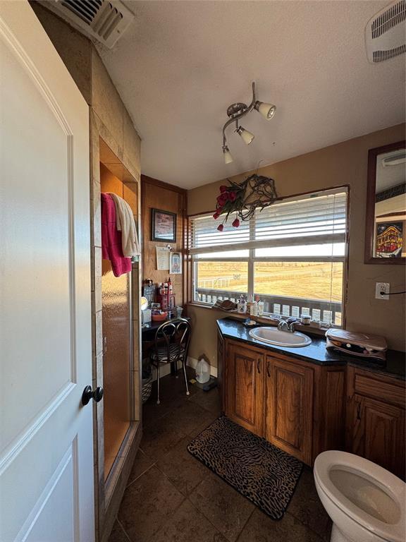 bathroom featuring a textured ceiling, sink, and toilet