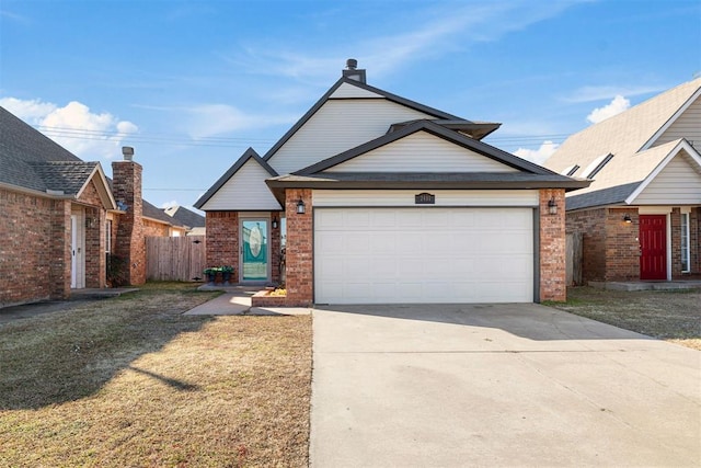 view of front of house featuring a garage and a front lawn