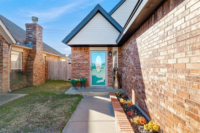 doorway to property featuring a lawn