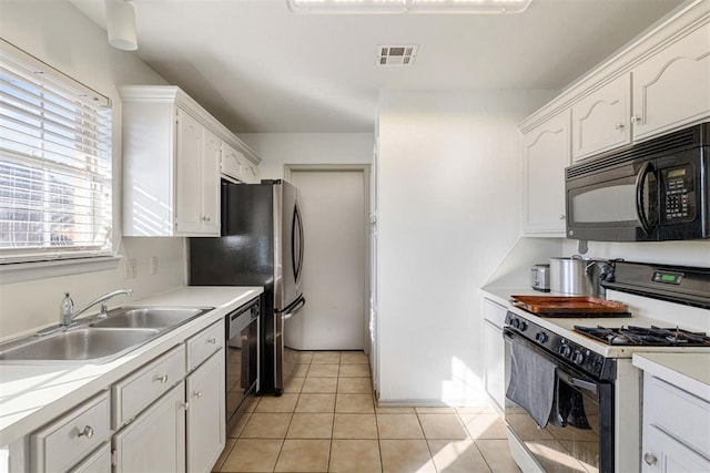 kitchen featuring sink, black appliances, white cabinets, and light tile patterned flooring