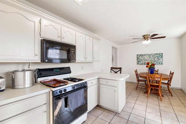 kitchen featuring light tile patterned floors, white range with gas stovetop, ceiling fan, white cabinets, and kitchen peninsula