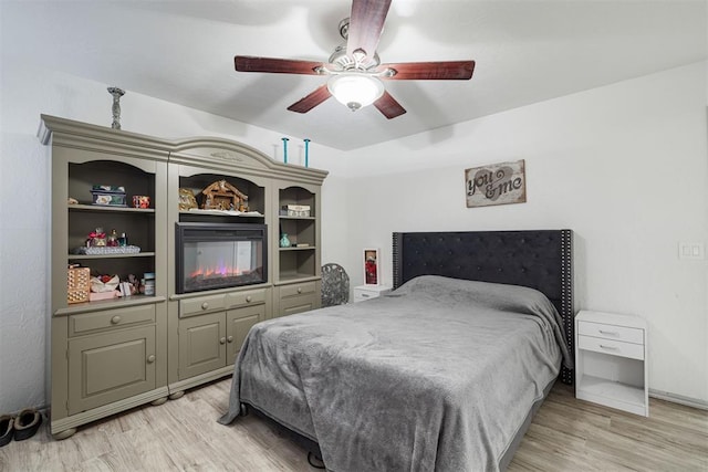 bedroom with ceiling fan and light hardwood / wood-style floors