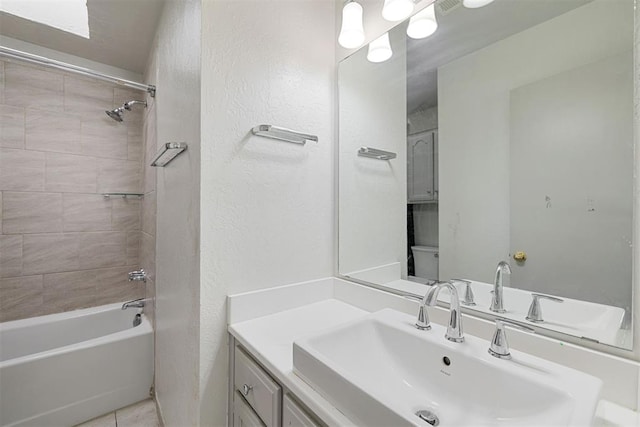 bathroom with tiled shower / bath, vanity, and tile patterned floors